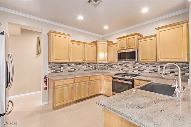 kitchen with light stone countertops, ornamental molding, stainless steel appliances, sink, and light brown cabinets