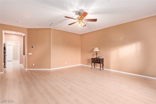 spare room featuring ceiling fan and light hardwood / wood-style flooring