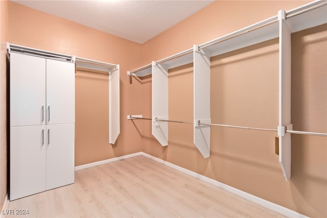 walk in closet featuring light hardwood / wood-style flooring