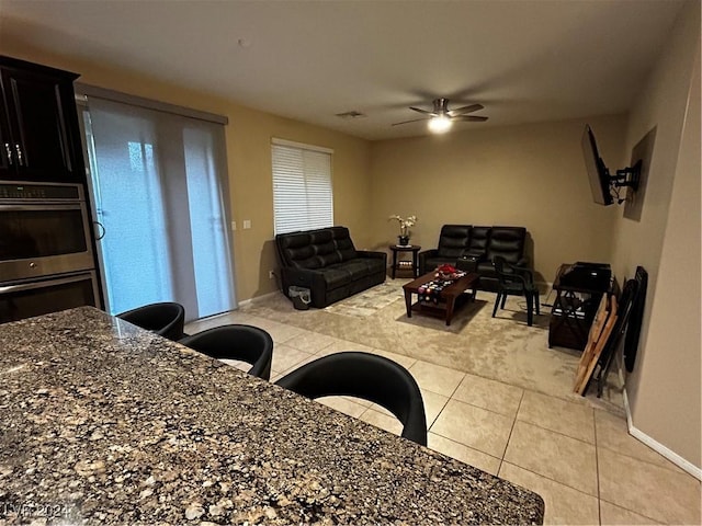 tiled dining room with ceiling fan