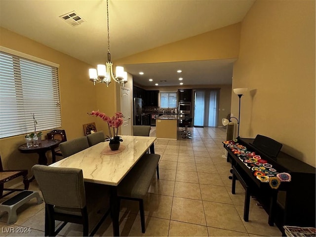 dining area featuring light tile patterned flooring, vaulted ceiling, and an inviting chandelier