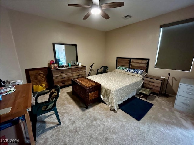 bedroom with ceiling fan and light carpet