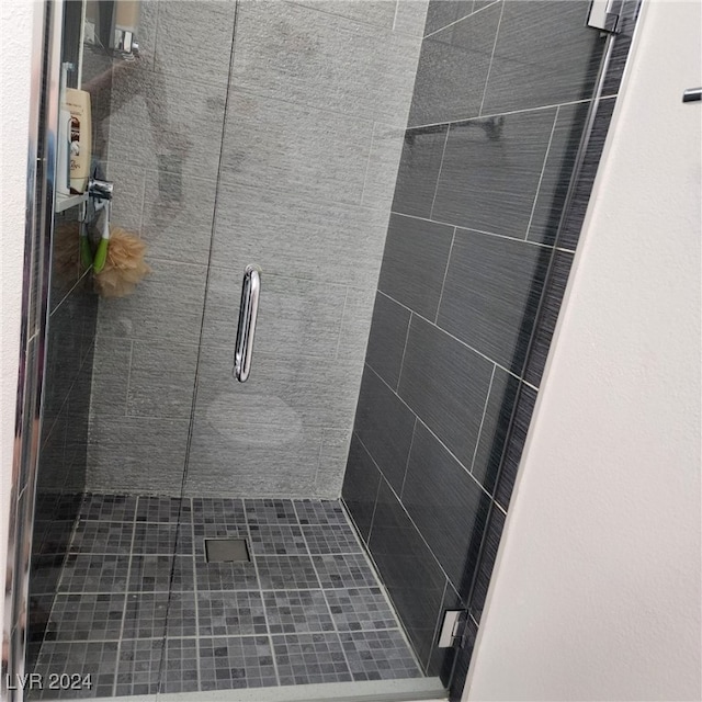 bathroom featuring a shower with door