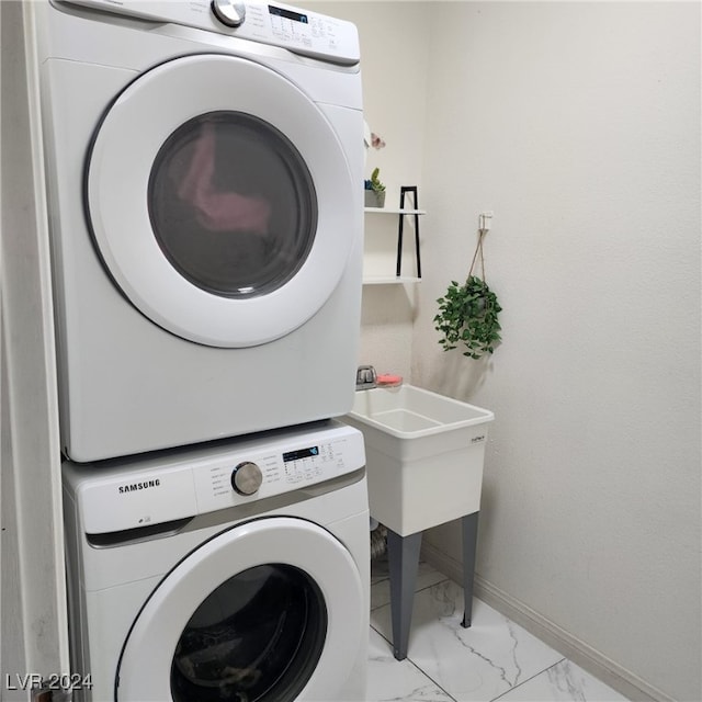 clothes washing area featuring stacked washer / drying machine