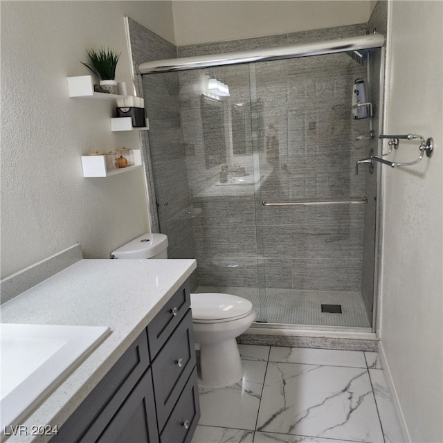 bathroom with an enclosed shower, vanity, and toilet