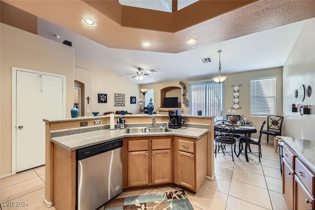 kitchen with ceiling fan, a center island with sink, stainless steel dishwasher, and sink