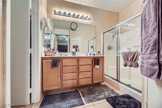 bathroom featuring tile patterned flooring, vanity, and an enclosed shower