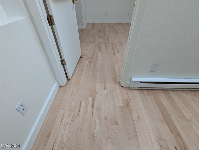 interior details featuring hardwood / wood-style floors and a baseboard radiator