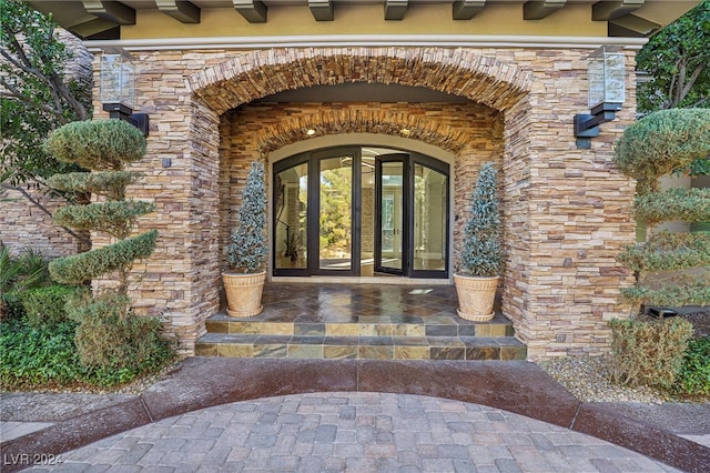 view of exterior entry featuring french doors