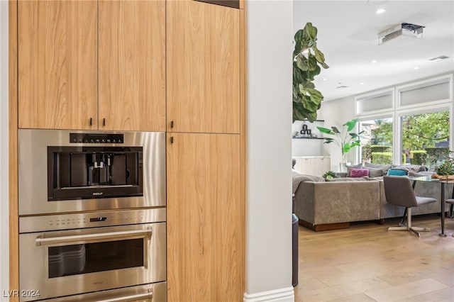 kitchen featuring light hardwood / wood-style floors and stainless steel double oven