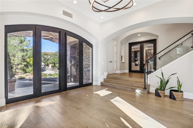 foyer featuring french doors and light hardwood / wood-style floors