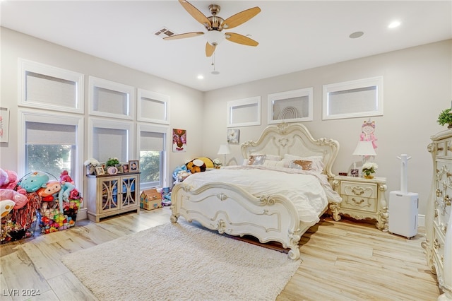 bedroom with ceiling fan and light hardwood / wood-style floors