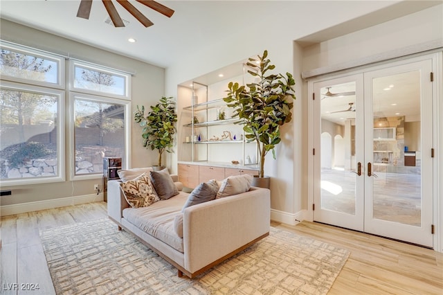 interior space with ceiling fan, light wood-type flooring, and french doors