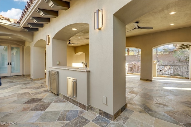 view of patio / terrace featuring ceiling fan, area for grilling, sink, and french doors