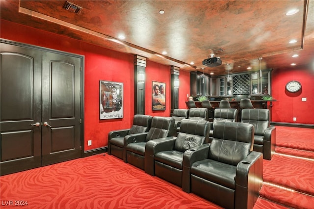 carpeted home theater featuring decorative columns