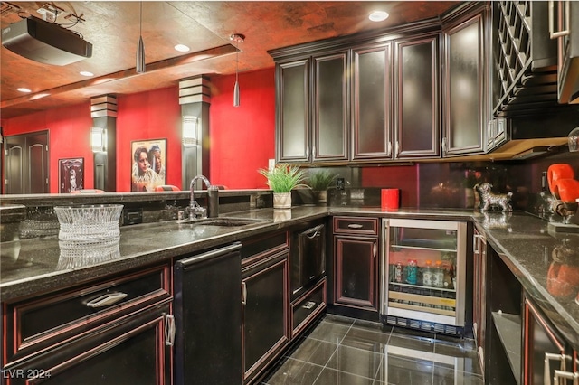 kitchen featuring dark stone counters, sink, hanging light fixtures, wine cooler, and dark tile patterned floors