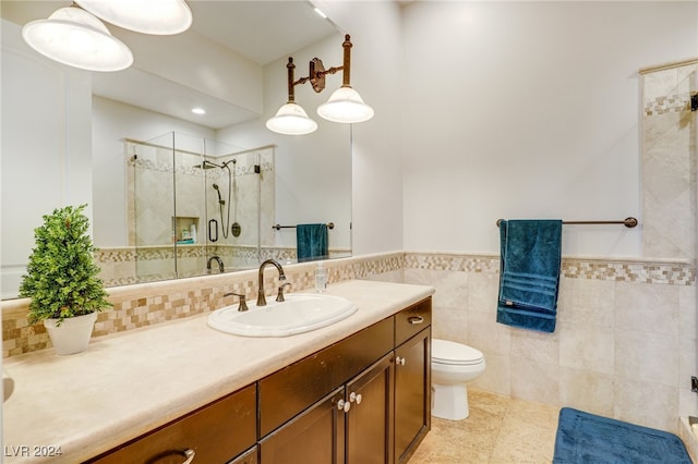 bathroom with tile patterned flooring, vanity, tile walls, and a shower with shower door