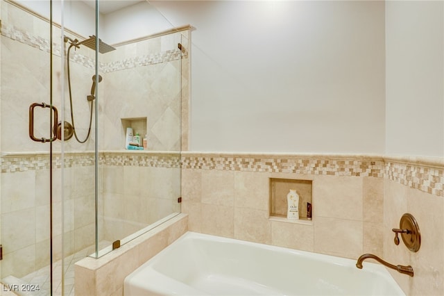 bathroom with separate shower and tub