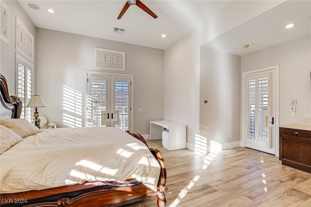 bedroom featuring access to exterior, ceiling fan, light hardwood / wood-style floors, and multiple windows