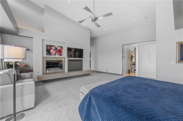 bedroom with carpet flooring, ceiling fan, and high vaulted ceiling