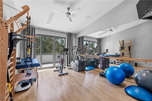 workout area featuring hardwood / wood-style floors, ceiling fan, and vaulted ceiling