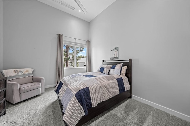 bedroom featuring carpet and high vaulted ceiling