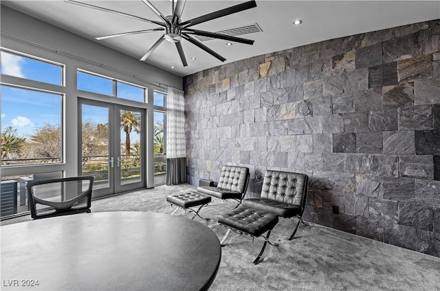 sitting room with ceiling fan, a healthy amount of sunlight, and french doors