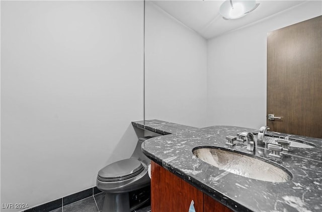 bathroom featuring tile patterned floors, vanity, and toilet