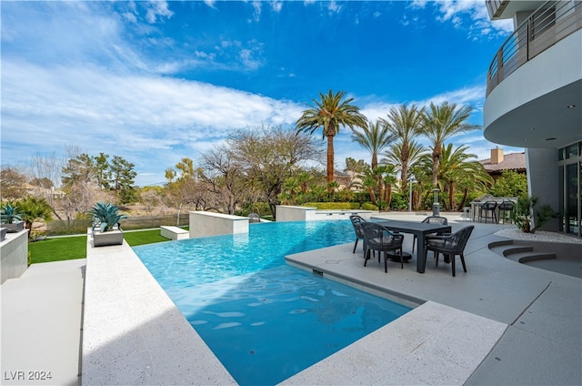 view of swimming pool with a patio area