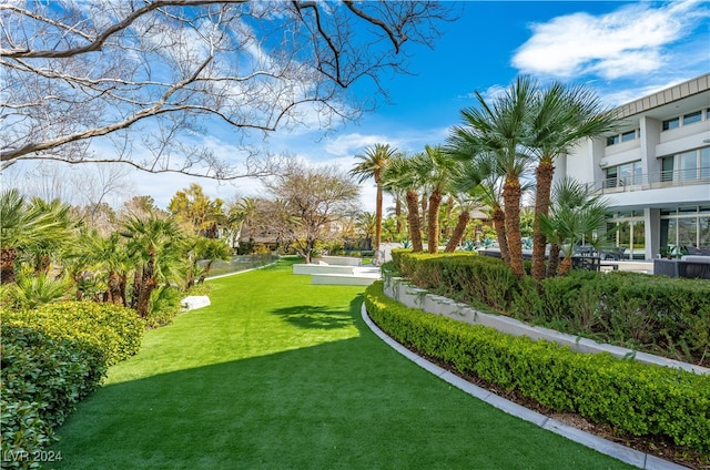 view of home's community featuring a lawn