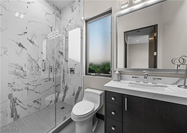 bathroom with vanity, a shower with shower door, and toilet