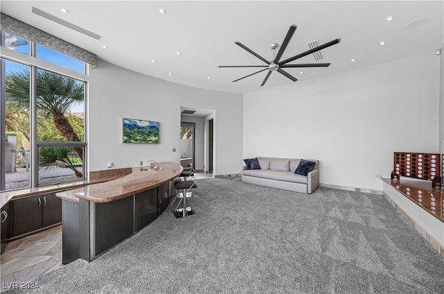 carpeted living room with ceiling fan