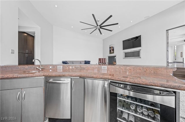 kitchen featuring gray cabinetry, light stone countertops, sink, ceiling fan, and wine cooler