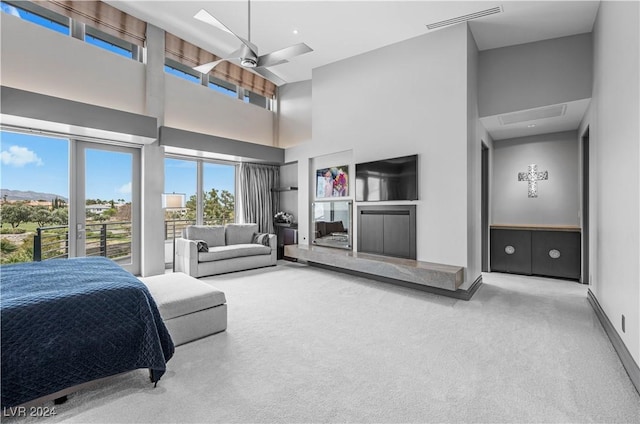 bedroom featuring a high ceiling, carpet floors, and ceiling fan