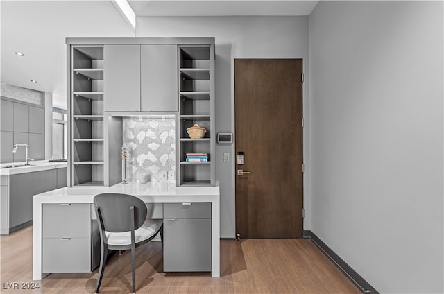 office featuring hardwood / wood-style flooring and sink