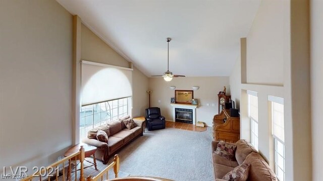 living room featuring high vaulted ceiling, ceiling fan, and carpet