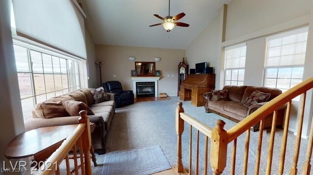 living room featuring ceiling fan, carpet flooring, and high vaulted ceiling