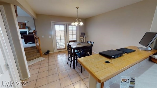 dining space with an inviting chandelier and light tile patterned floors