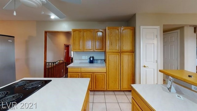 kitchen with black electric cooktop, ceiling fan, and light tile patterned flooring