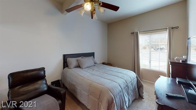 bedroom featuring lofted ceiling, light colored carpet, and ceiling fan