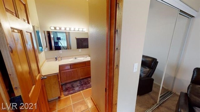 bathroom with tile patterned floors and vanity
