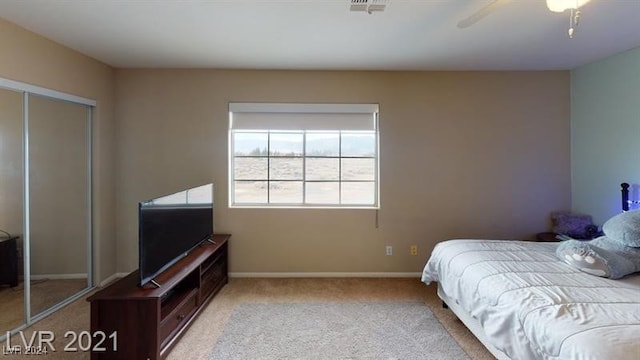 carpeted bedroom with a closet and ceiling fan