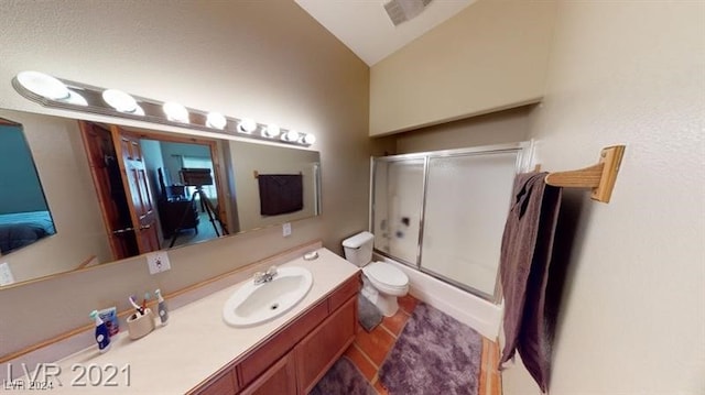 full bathroom with vanity, lofted ceiling, enclosed tub / shower combo, and toilet