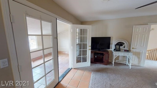 doorway to outside with french doors and light colored carpet