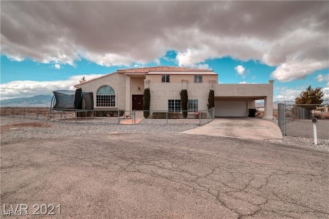 view of front of house featuring a garage and a trampoline