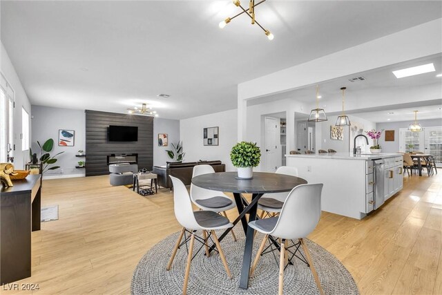 dining room featuring plenty of natural light, sink, and light hardwood / wood-style flooring