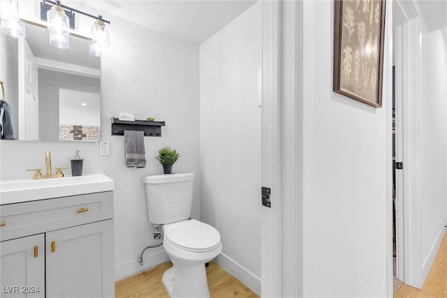 bathroom featuring hardwood / wood-style floors, vanity, and toilet