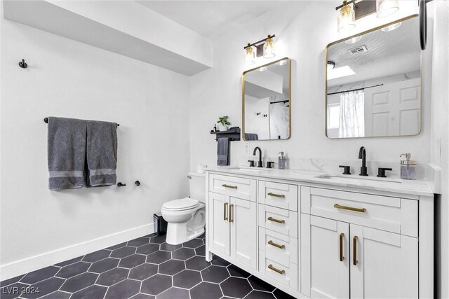 bathroom with tile patterned floors, vanity, and toilet