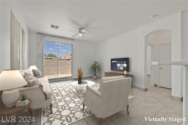 tiled living room with ceiling fan