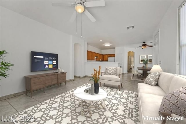 tiled living room featuring ceiling fan